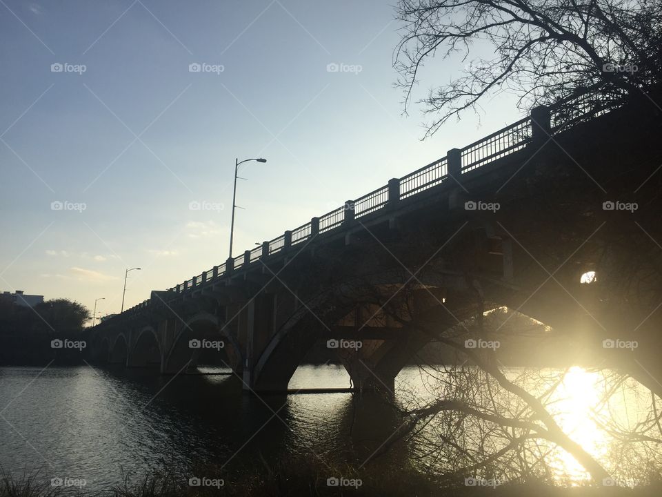 Sunset over bridge and water in Austin, TX