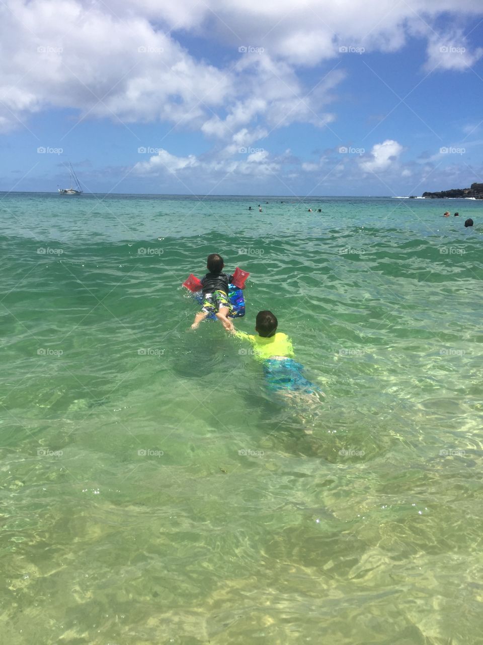 Brothers swimming at the beach