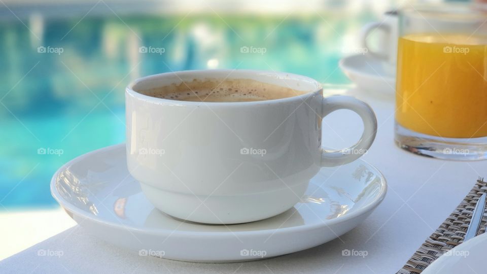 Morning ritual - having a big cup of caffe latte and a glass of fresh squeezed orange juice 