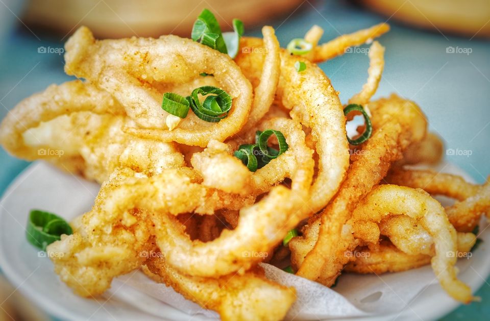 Salt and pepper deep fried squid. A popular food item in most yum cha or dim sum line up. A crispy and golden brown delight.