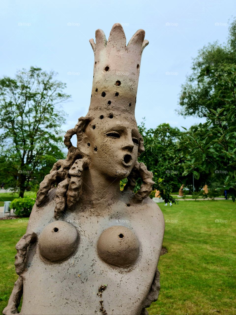 a beautiful clay sculpture of a woman in a  public city park in Jelgava, Latvia