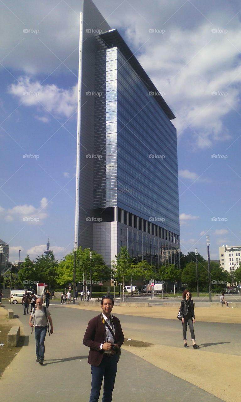 handsome man standing in the messe square in frankfurt
