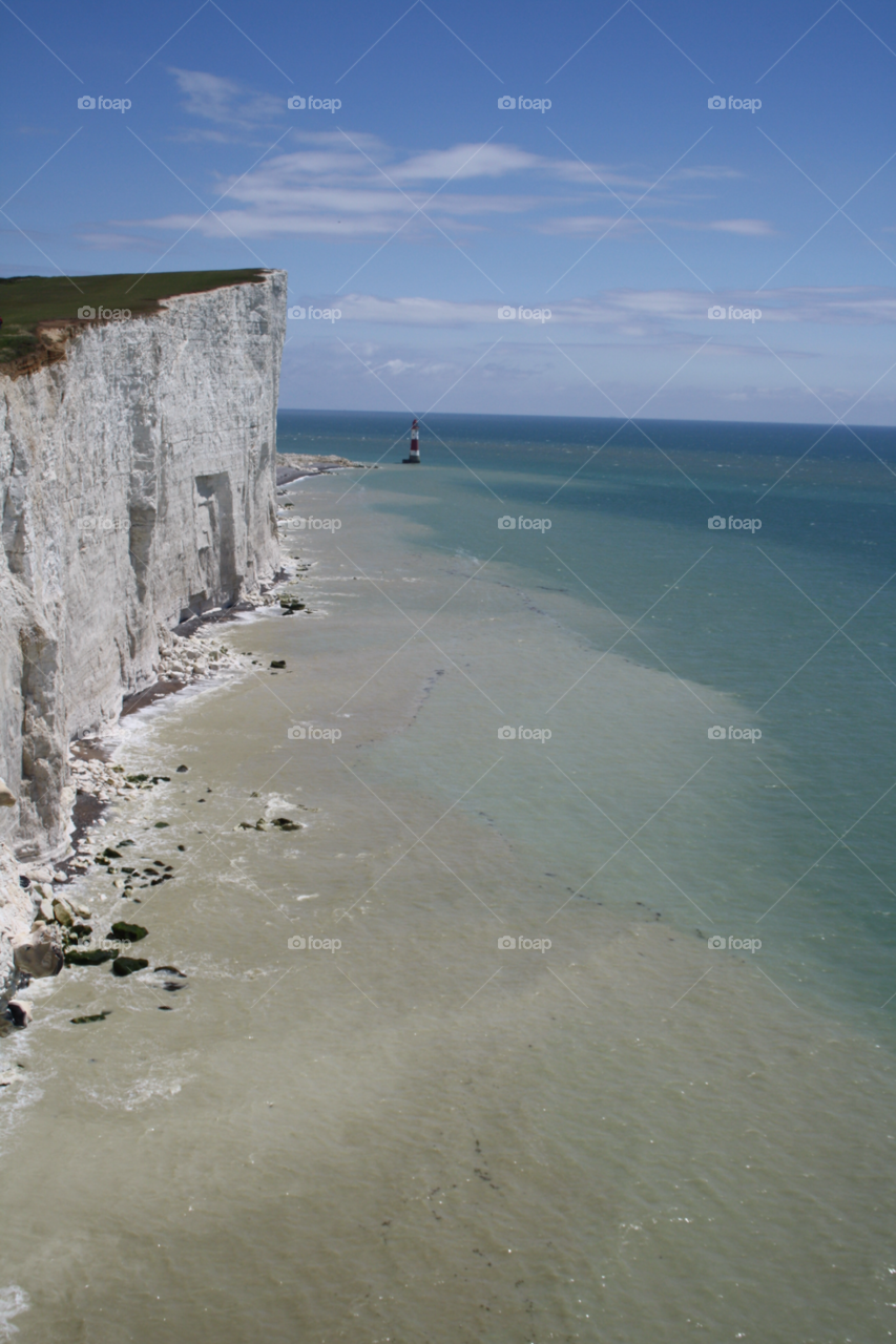 summer rocks lighthouse blue sky by leonbritton123