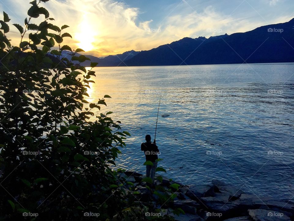 backlit fisherman