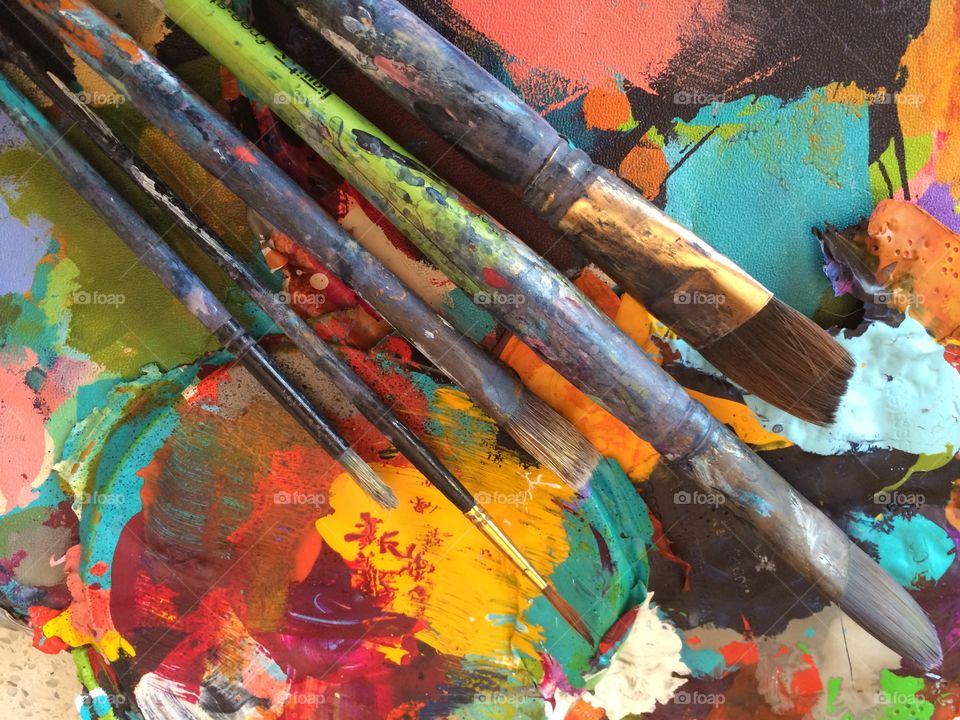 Paintbrush on messy palette