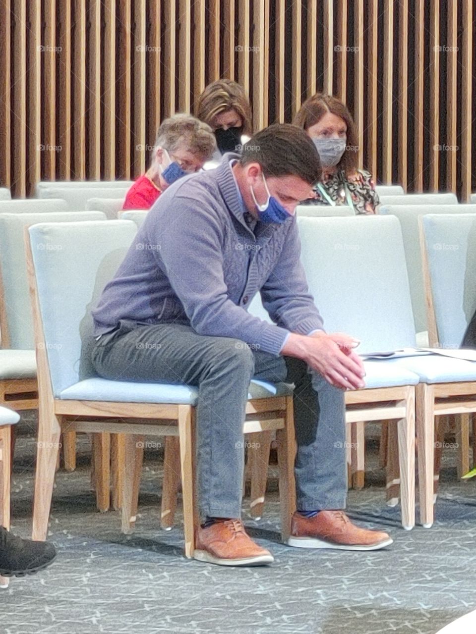 Pastor Chris Woodard praying at church