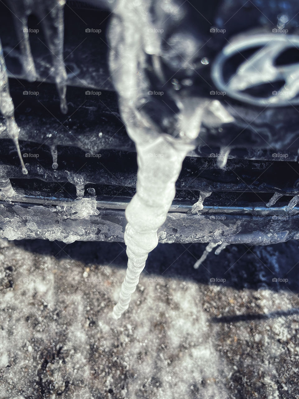 Large icicle stuck to front of a car 