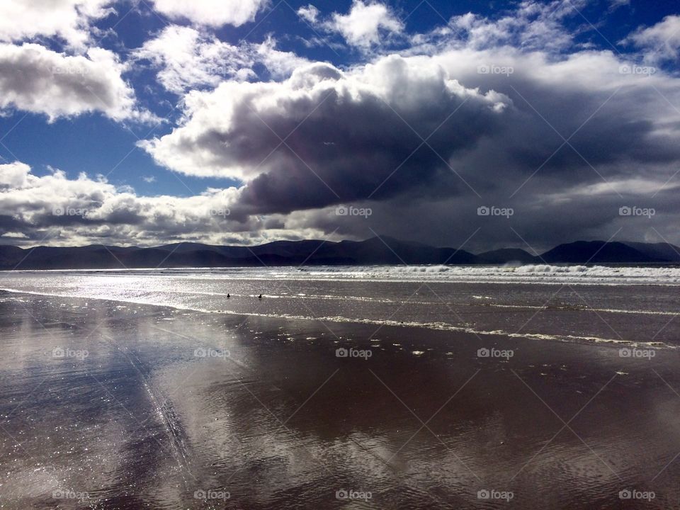 Where sky meets the sand - ocean .