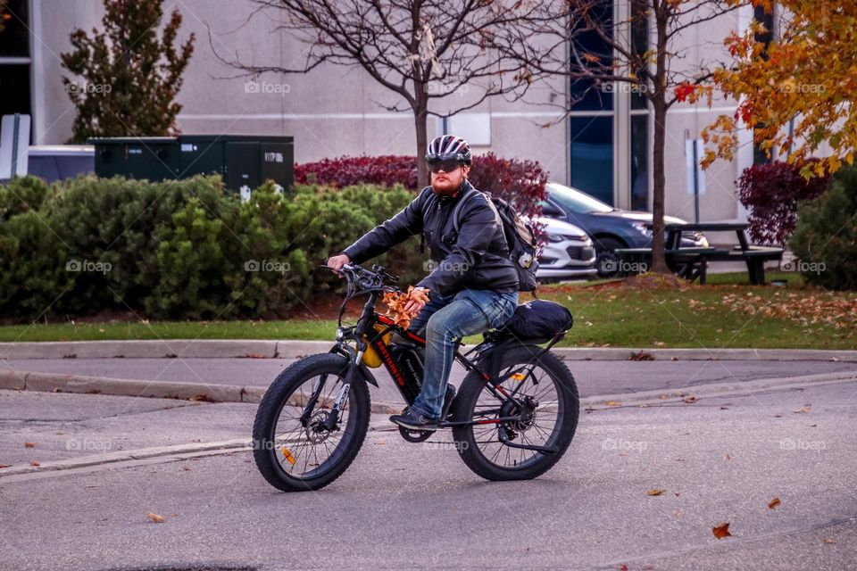 Young man is riding an electric bike