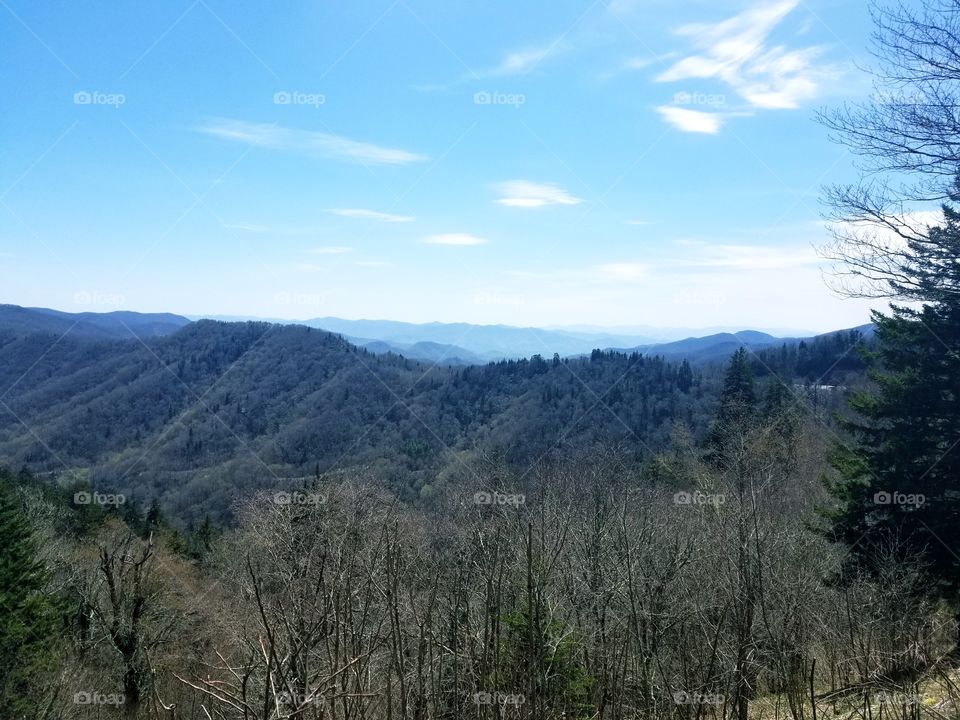 Breathtaking panoramic sweeping views of vibrant blue skies of the Great Smoky Mountain national park/forest with rolling clouds over North Carolina & Tennessee.