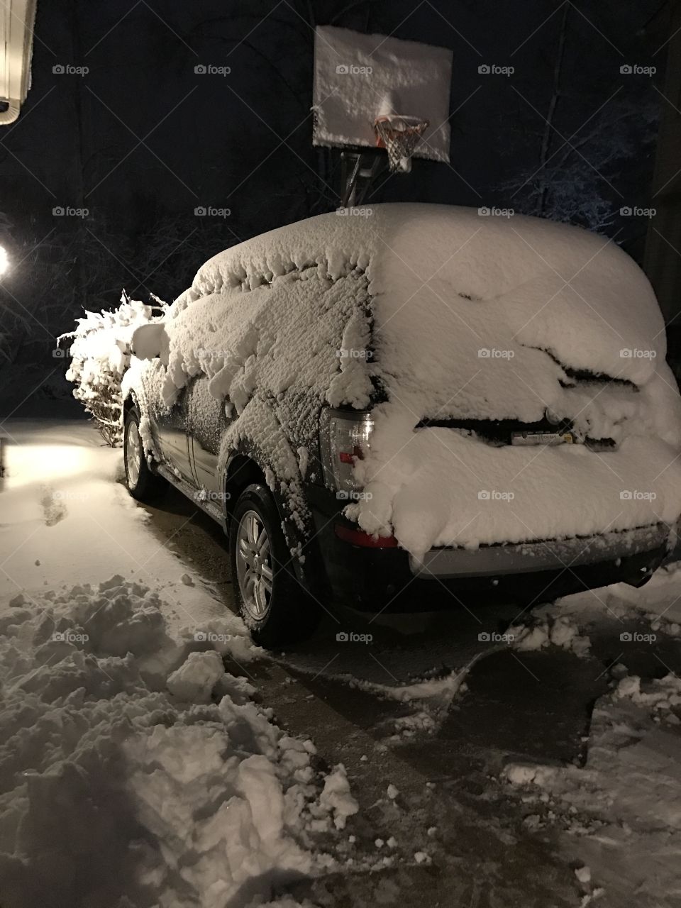 Car blanketed with heavy snow.  