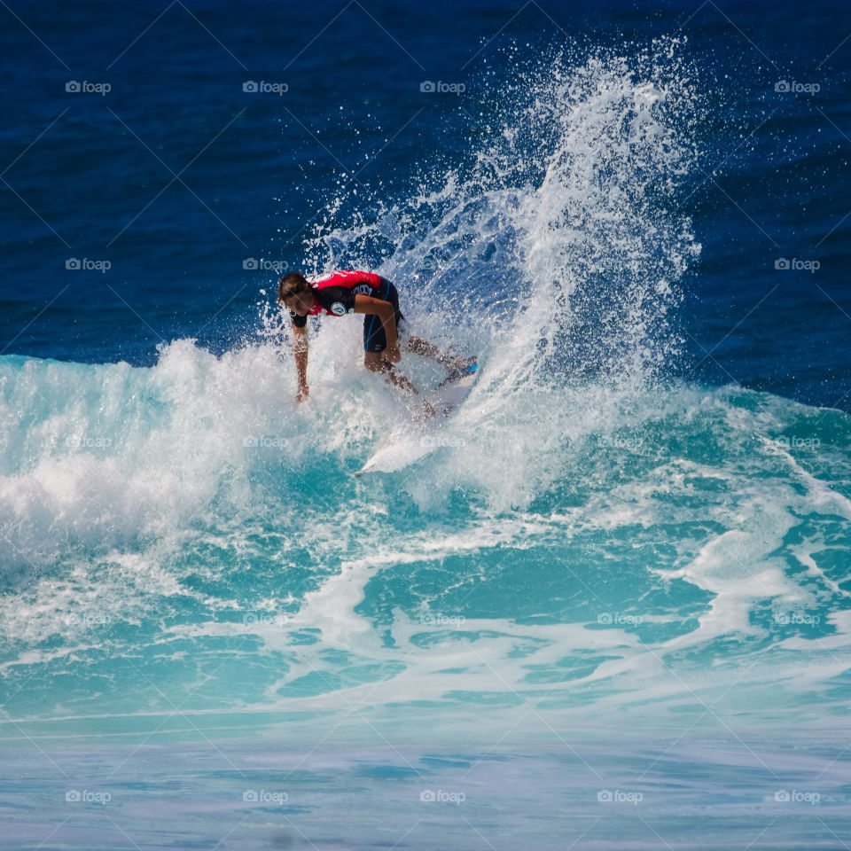 A surfer on a see with splash