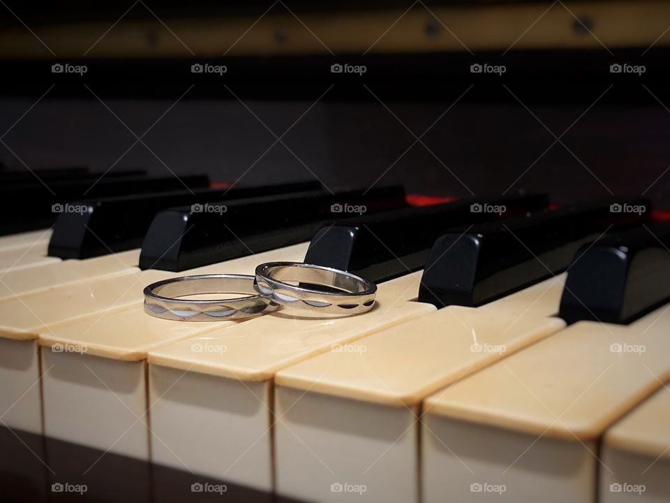 Wedding rings resting on the Piano keys, just waiting for their time to shine. In the shape of a circle, it represents continuous love, no ending and no begging, the never ending cycle. A beautiful representation for the love between two people.