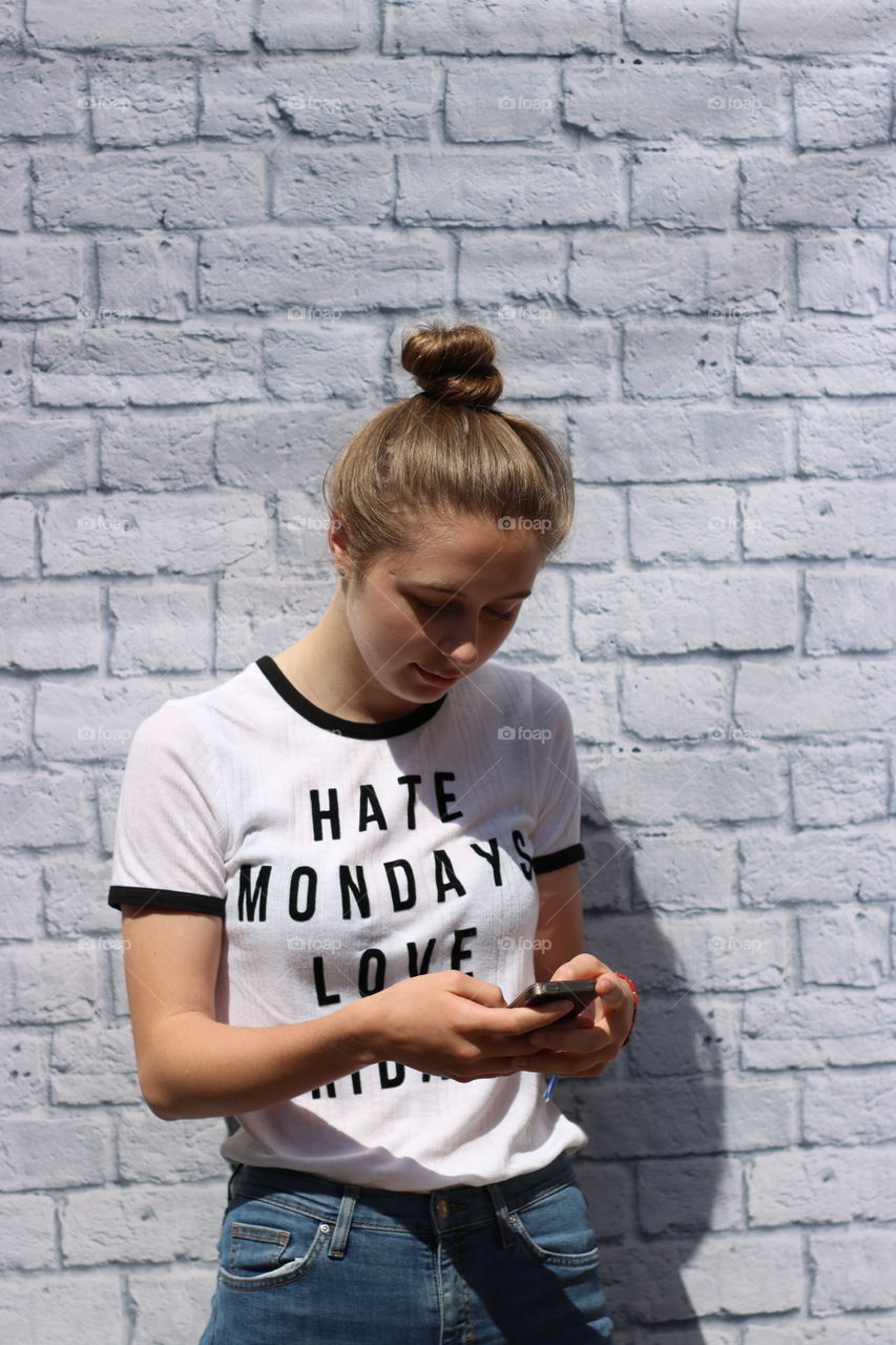 Young woman standing with mobile phone