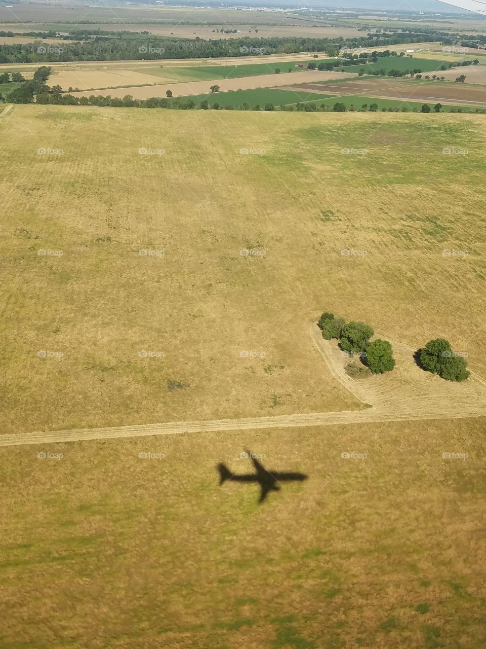 Airplane shadow on land