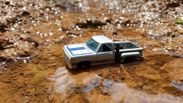 miniature photo of a car crossing a river