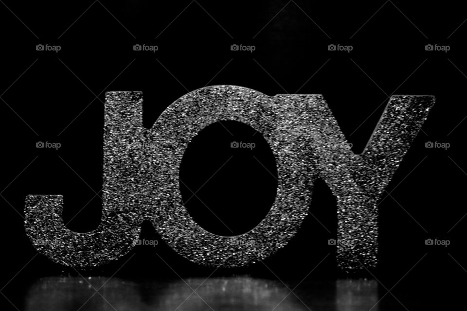 The word Joy in display against a black background 