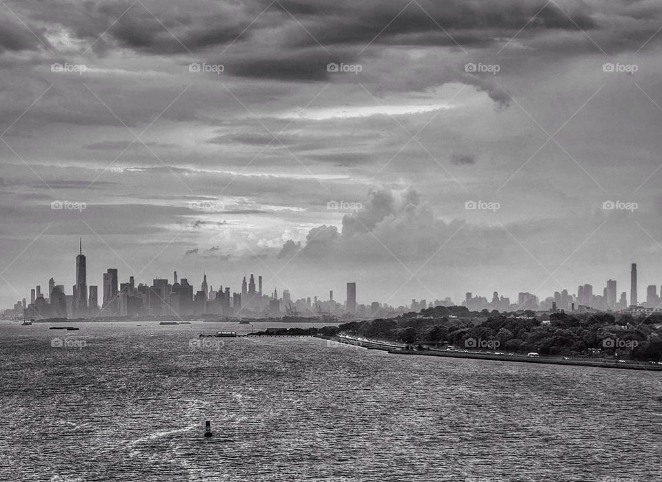 Manhattan and Brooklyn skyline behind Governors Island seen from the middle of New York Harbor 