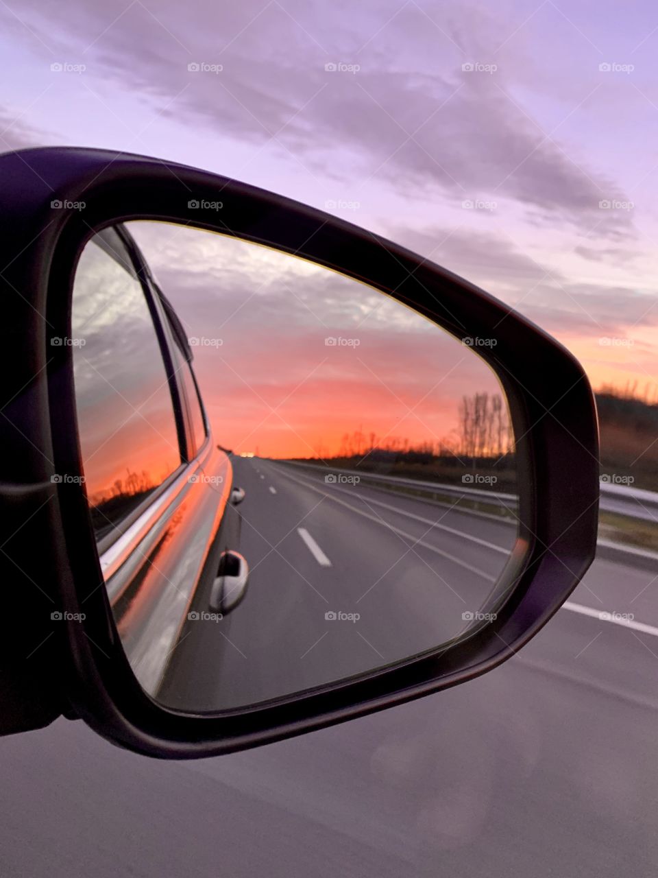 Autumn ... evening ... track ... sunset ... A fiery red sunset is reflected in the car mirror