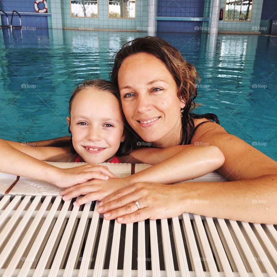 Mother daughter swimming. 