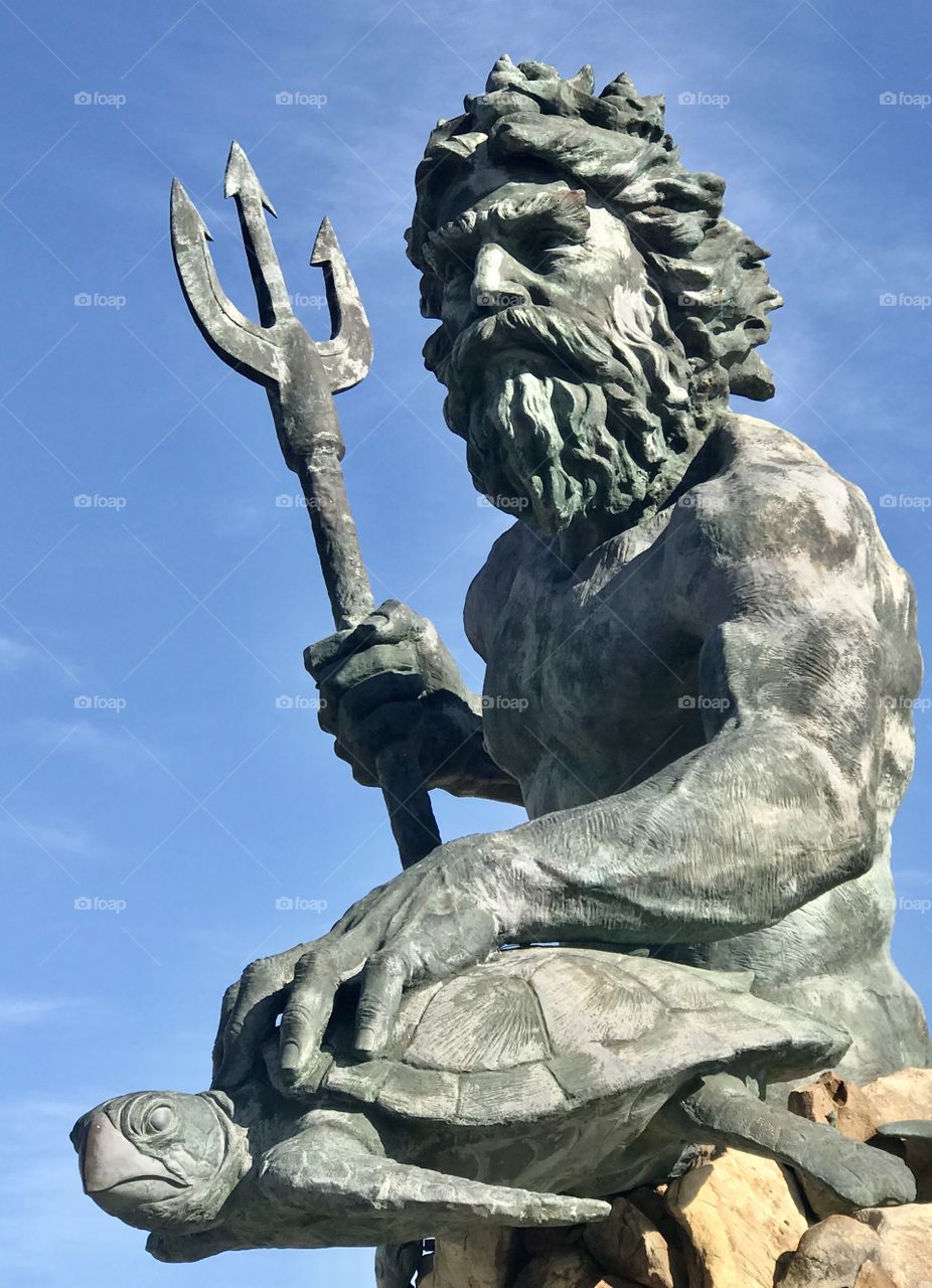 Neptune statue with a sea turtle 