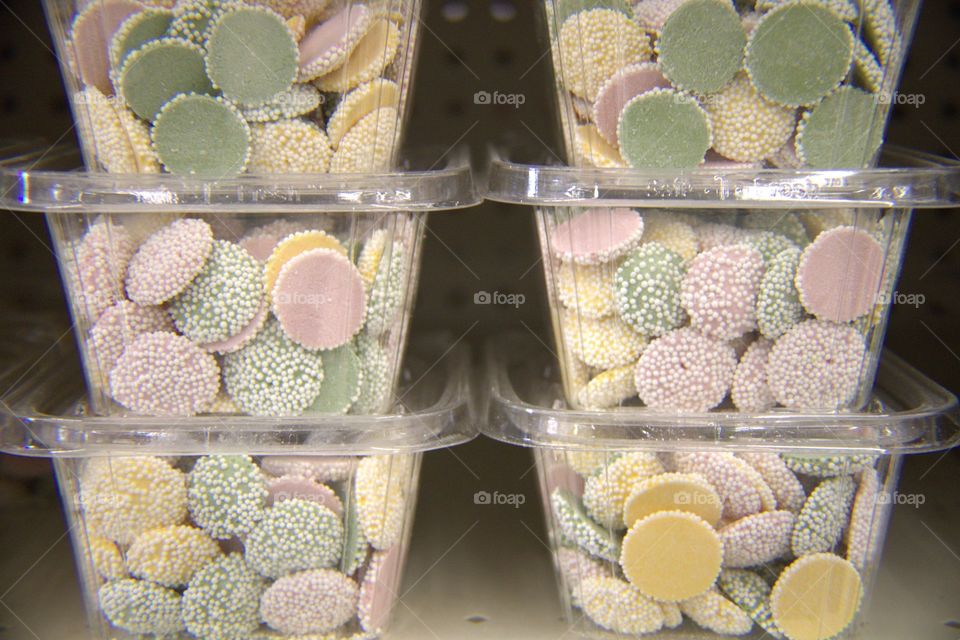 Multi-Colored White Chocolate Dots Covered with White Micro Dot Candy in Stacked Containers
