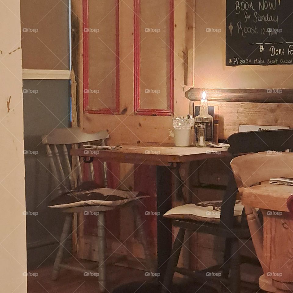 cosy candlelit dinning area table and chairs evening candle restairant