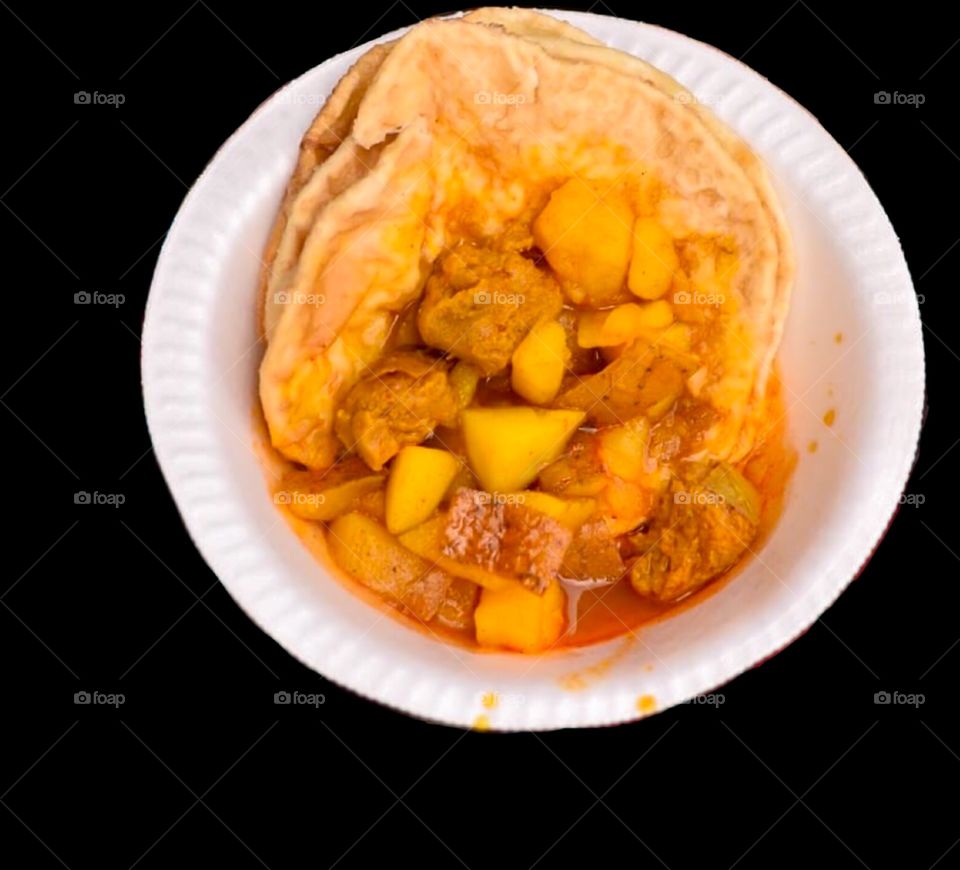 Indian traditional dish. Luchi and curry. Luchi is a deep-fried flatbread, made of flour, originating from the Bengal region.Luchi is especially popular in the Indian states of Assam, Bihar, Odisha, West Bengal and Tripura 