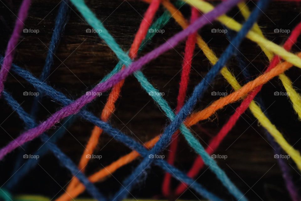 Colorful string triangles, string art makes triangles, geometric shapes in art, string makes triangles within art, geometric shapes around the house, closeup of triangles 