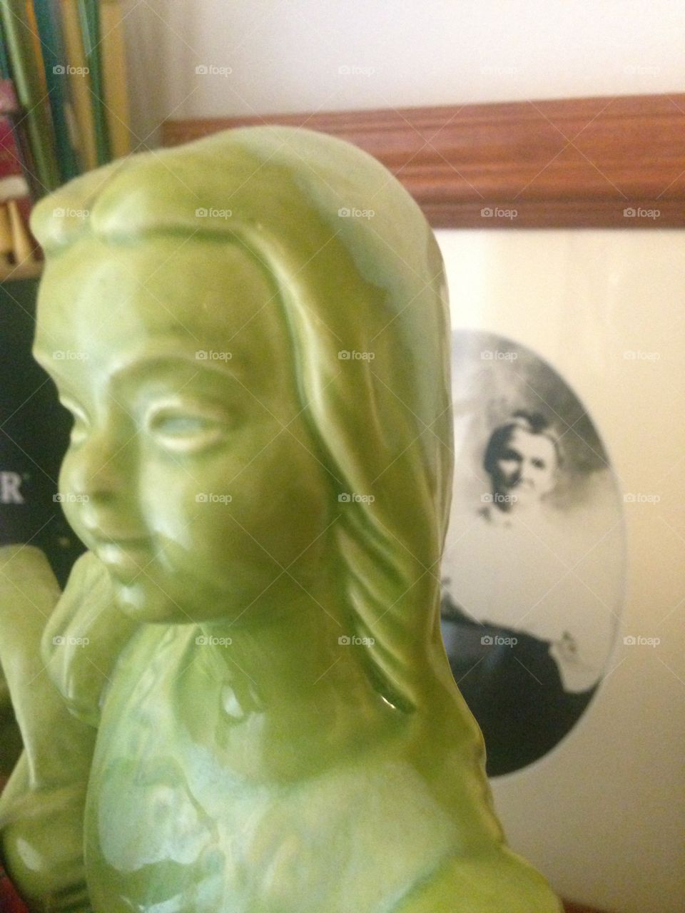 Old photograph behind green sculpture
