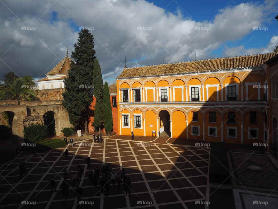 Palace. Yard. Sunset. Shadow. Tree. Clouds
