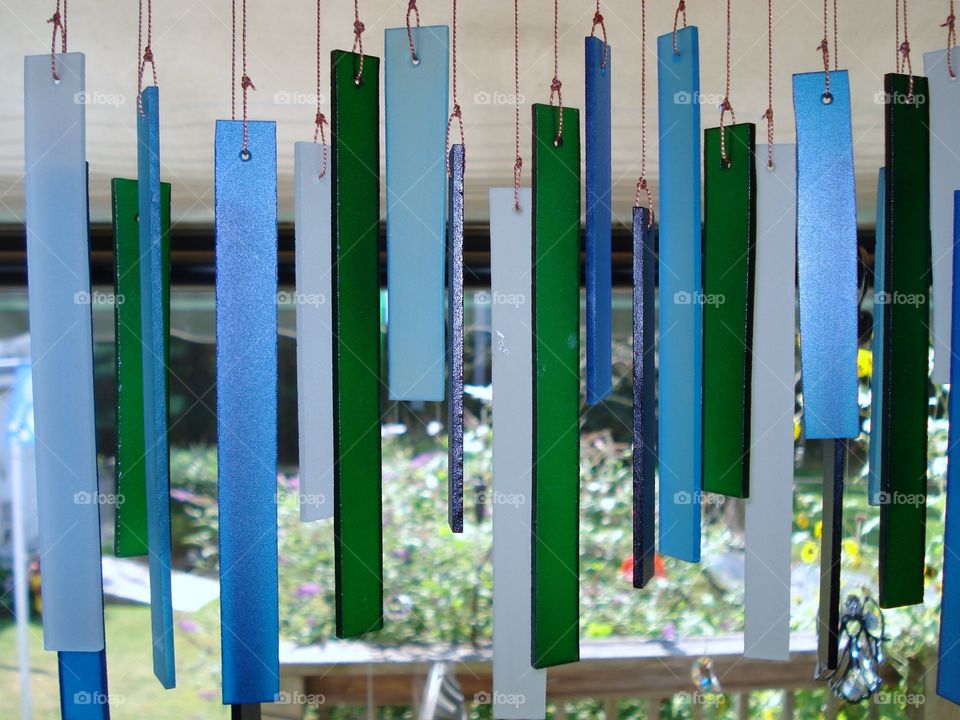 Glass Wind Chimes in Shades of Blue. Reminded me of Sea Glass & sound so delicate😊Tied to a piece of driftwood. I watched them made in an artistic shop.