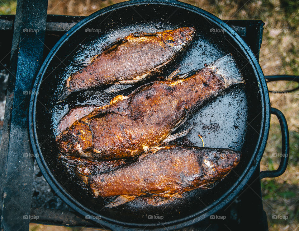 Fried fish on cast iron pan