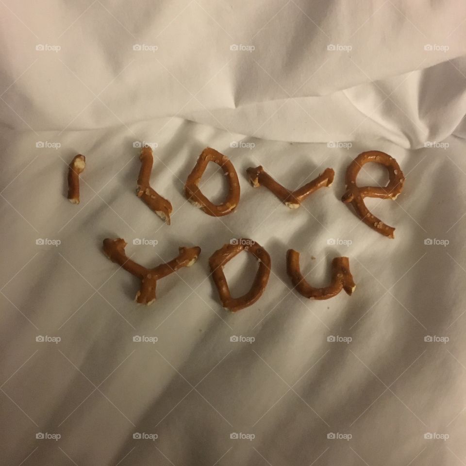 Pretzels bitten into letters, to spell out “I love you”.