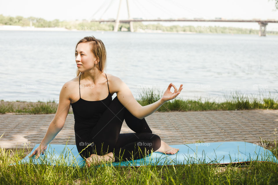 young woman doing yoga in the park