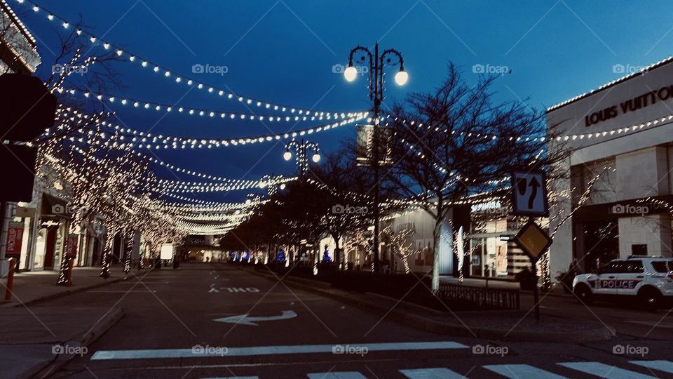 An early morning commute to the local Coffee bar. Few are out on this cold morning, but no doubt they have the same goal in mind. They’re greeted by holiday lights not yet taken down. Beautiful accents to the buildings and trees.