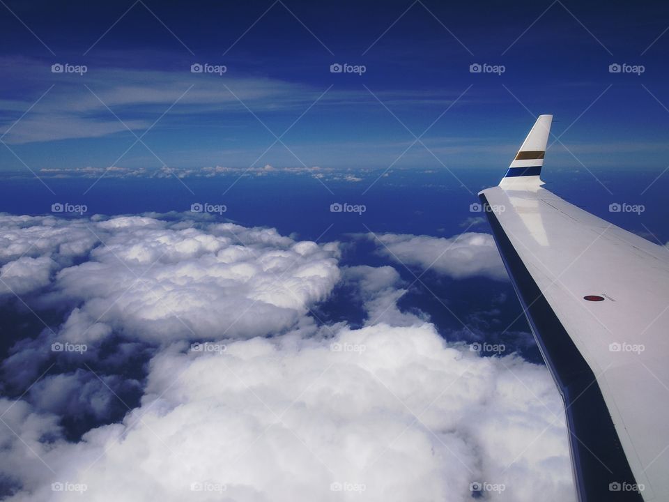 sky, clouds and a wing of an airplane