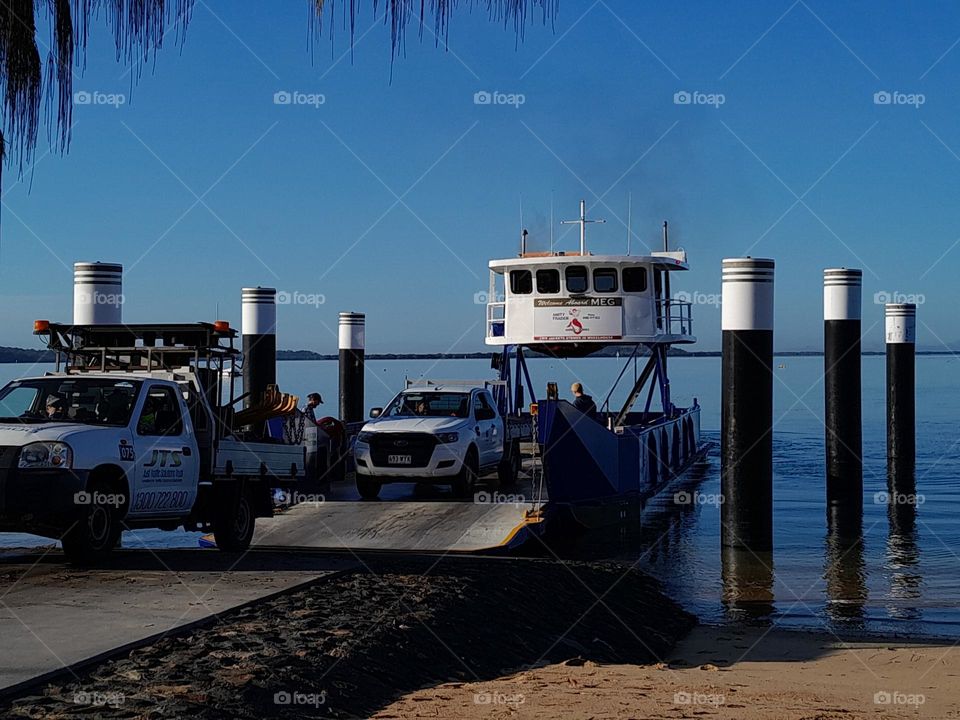 Workers driving off Island Barge