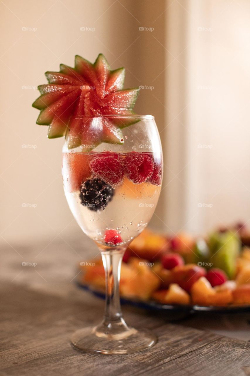 A glass of aqua mineral and fruits