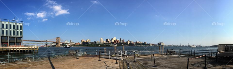 Brooklyn and Brooklyn Bridge viewed from Pier 17, at South Street Seaport, Manhattan, New York - USA, in a sunny day.