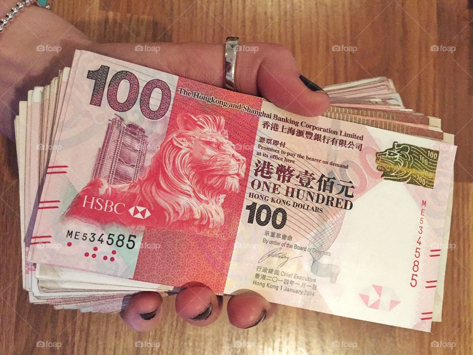 A person holding Hong kong dollars
