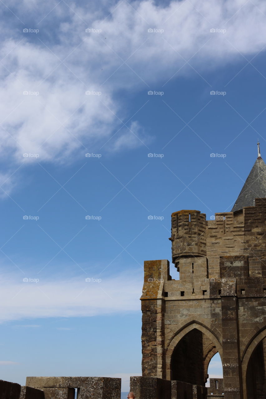 Picture of a castle with a blue sky in the background