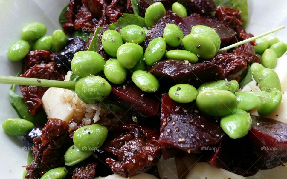 Edamame beets quinoa spinach black pepper heart of Palm salad up close in macro