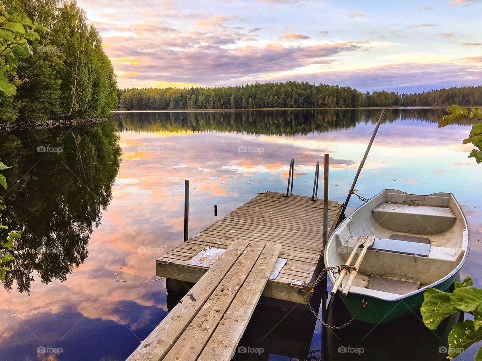 Moored boat and reflection of trees