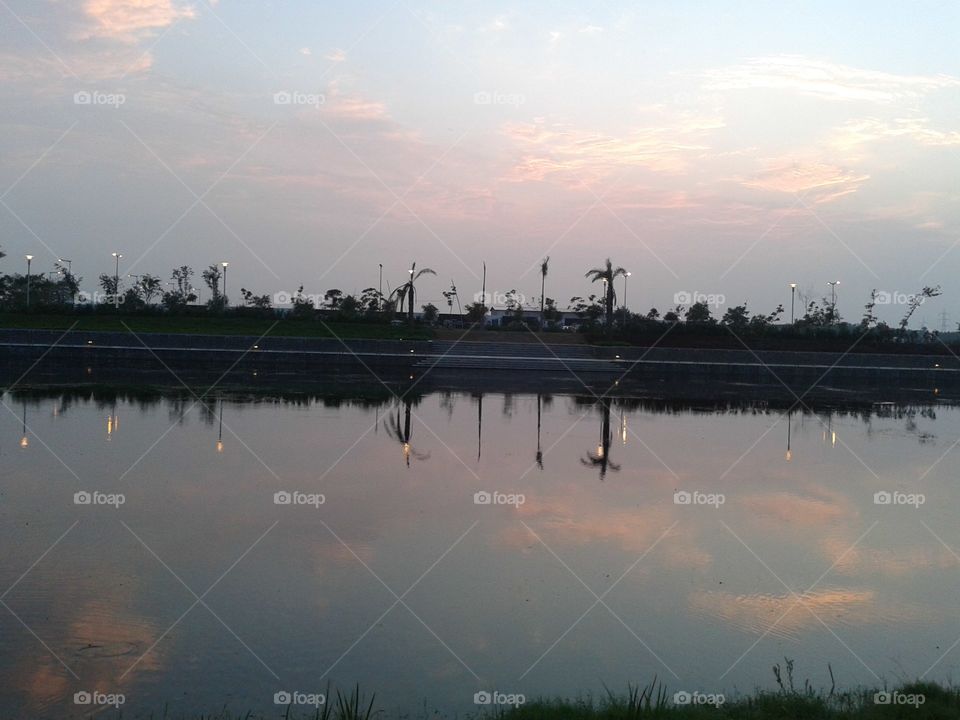 Reflection of trees and clouds in water