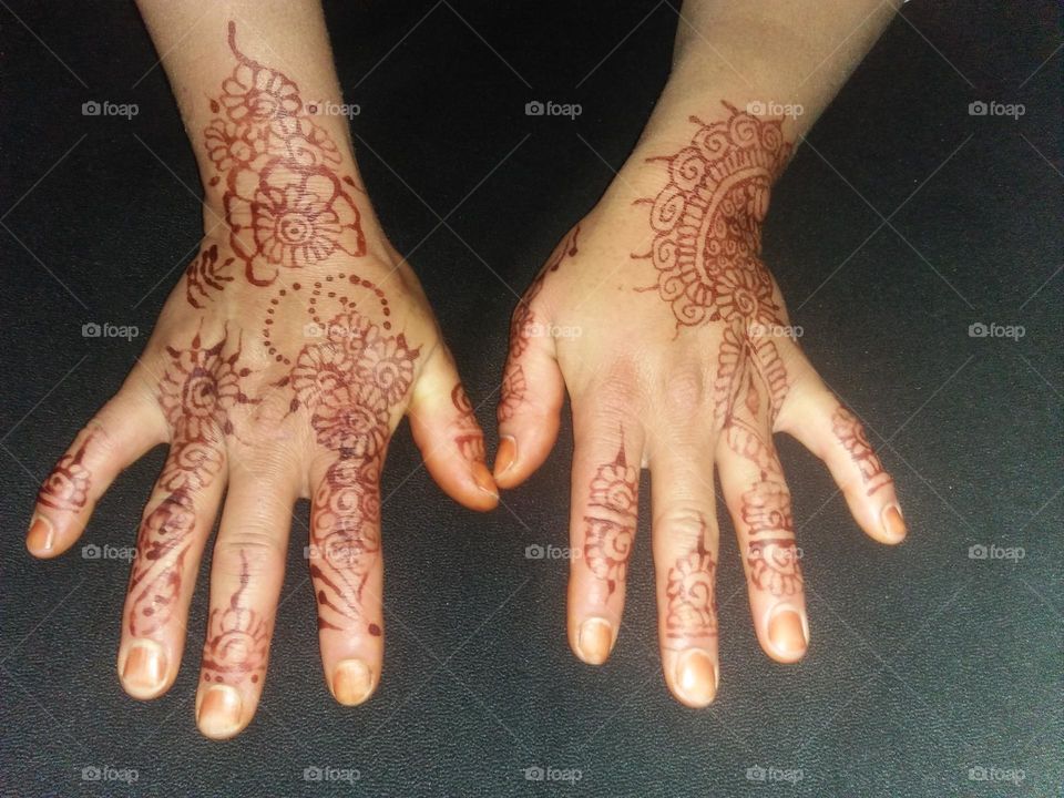 Two beautiful hands decorated by henna.