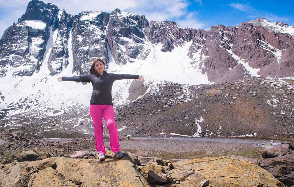 woman arms stretched on the mountain