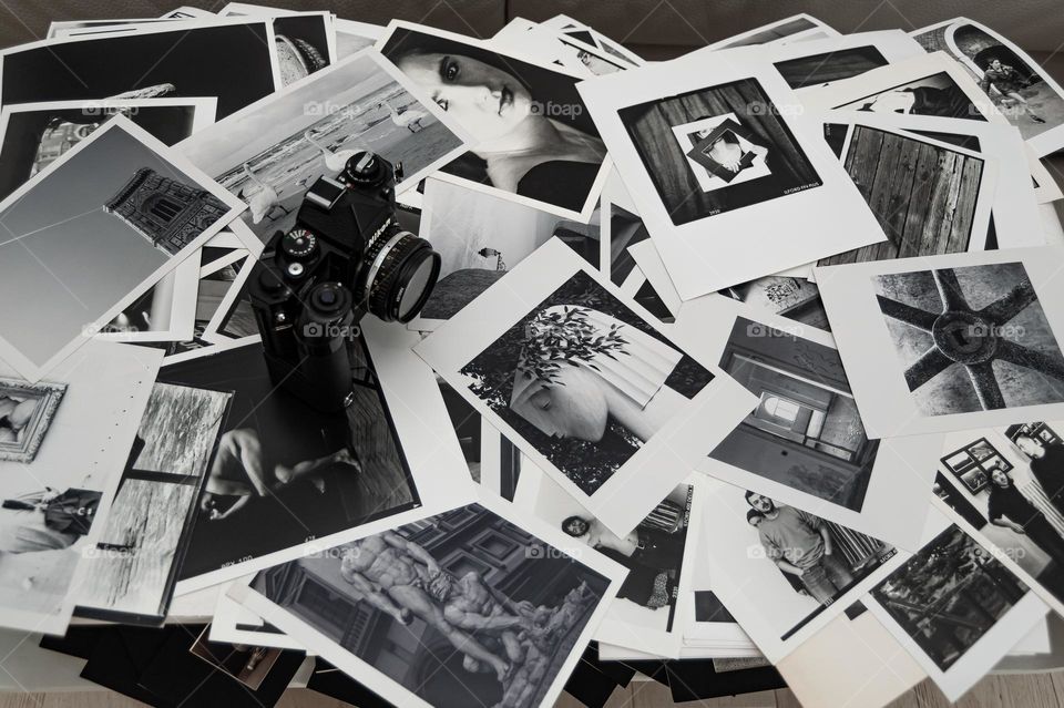 Photography. Camera and black and white photo prints.