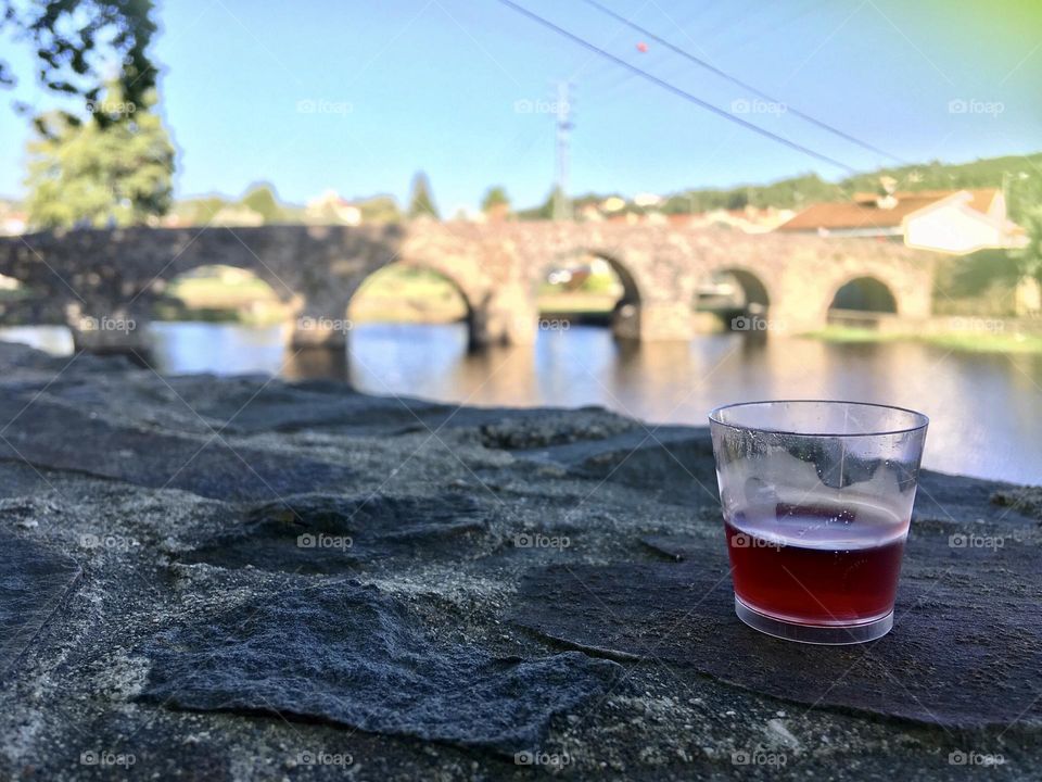 Drink outdoors by the bridge 