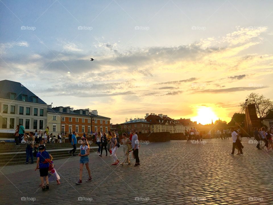 sunset on castle square of warsaw, activities on old town square of warsaw city, capital of poland, europe